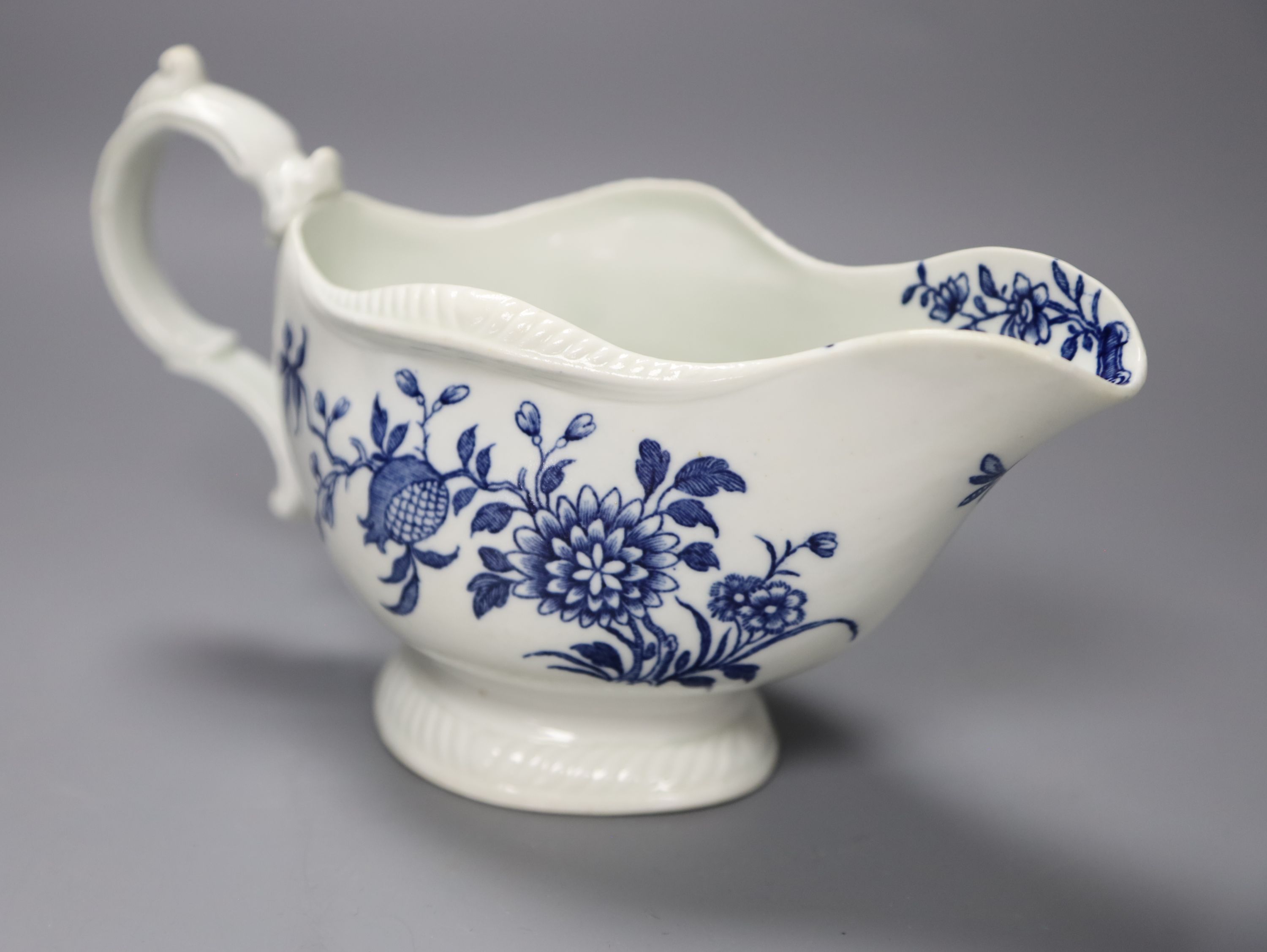 An 18th century Worcester sauceboat decorated with the Early Flowering Plants pattern, length 21cm
